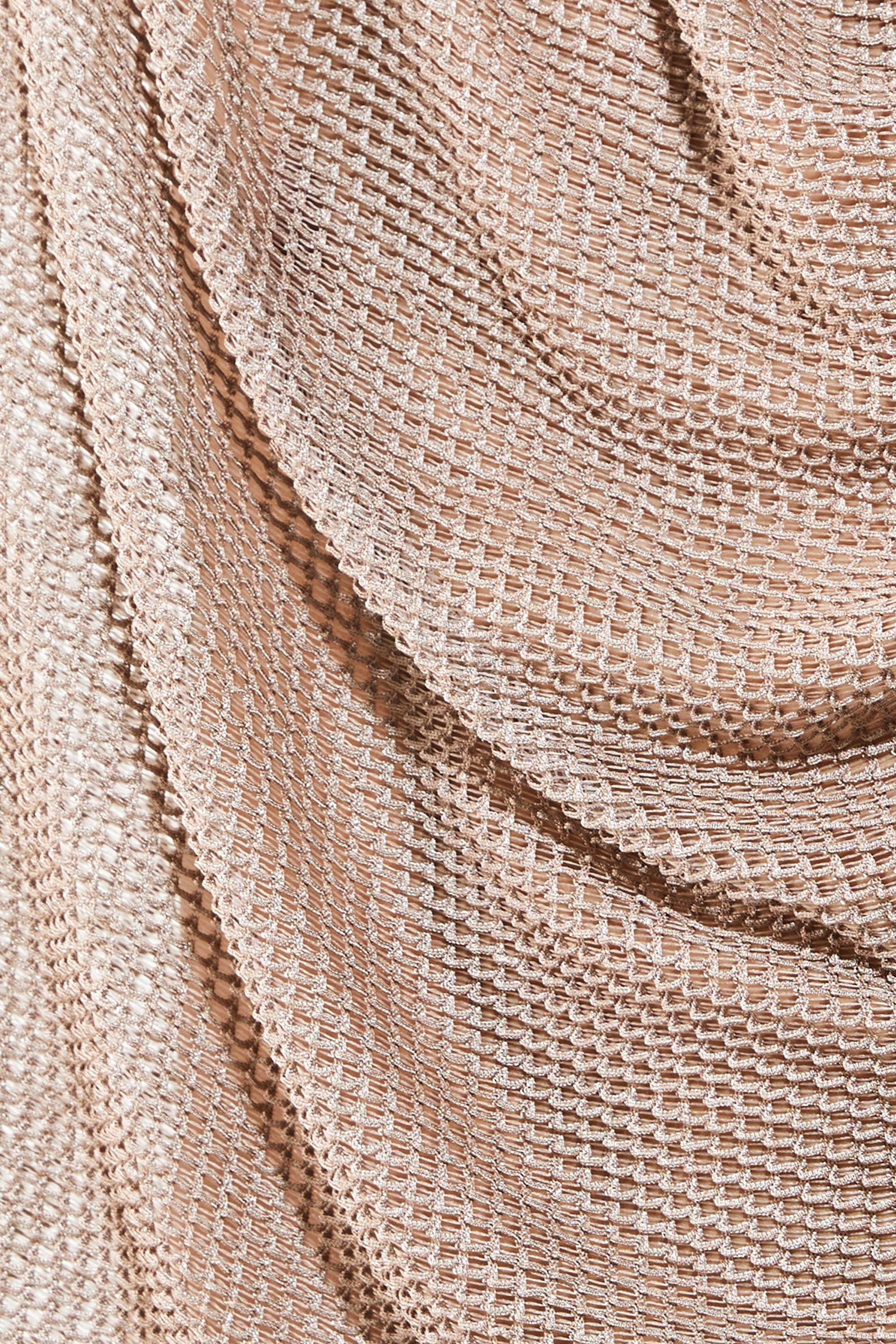 Close-up detail of breathable open-knit mesh fabric texture in beige showing see-through construction. Loose-weave knit pattern creates airy ventilation perfect for hot weather festivals and beach events. Durable yet lightweight material maintains shape while allowing maximum air circulation. Ideal for gay rave outfit, festival wear, and casual summer style where comfort meets bold transparent aesthetic. Unique texture adds visual interest to relaxed jogger silhouette.