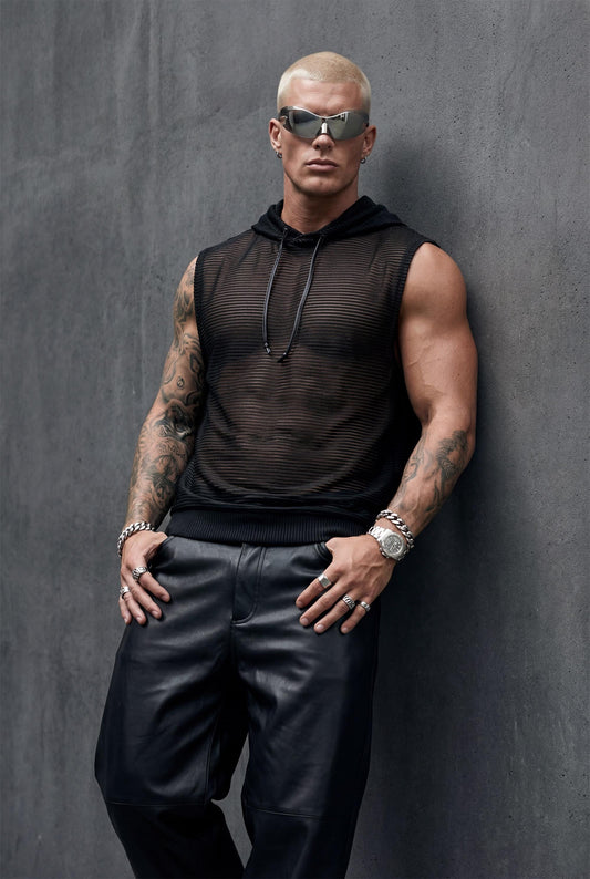 Men's black transparent hooded tank second front angle displaying relaxed fit and metallic striped mesh fabric. Essential rave wear for festivals, circuit parties, and pride outfits. This sleeveless sheer top combines breathable comfort with bold style perfect for club nights, beach gatherings, or alternative streetwear. Lightweight nylon-lurex blend creates subtle shimmer for confident gay fashion and LGBTQ+ event wear.