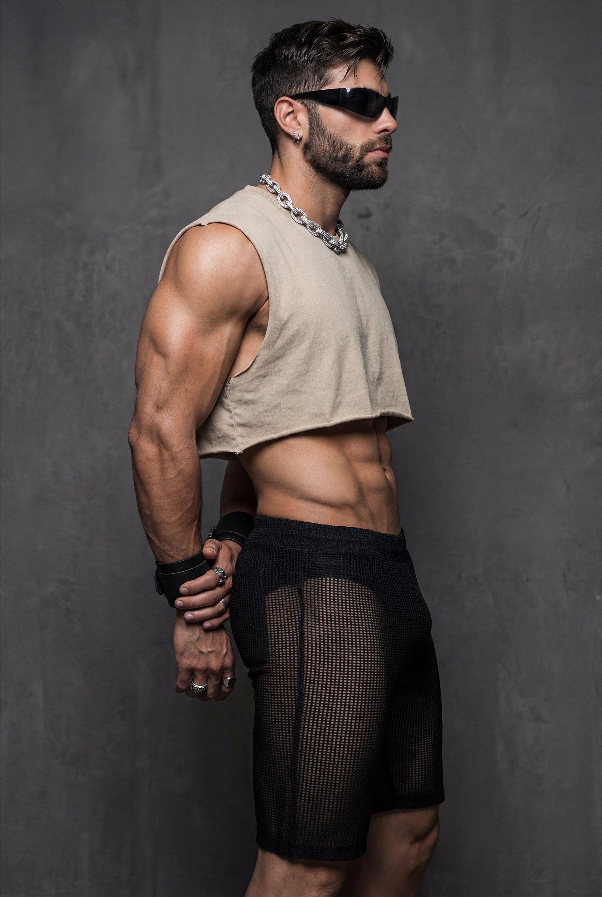 Side profile of see-through mesh shorts on a toned male body. Lightweight mesh follows the legs and highlights muscle definition. Ideal for gay party looks, Berlin underground clubs, raves, and festival wear. Transparent club shorts made for dancing, heat, and high-energy LGBTQ nightlife scenes.