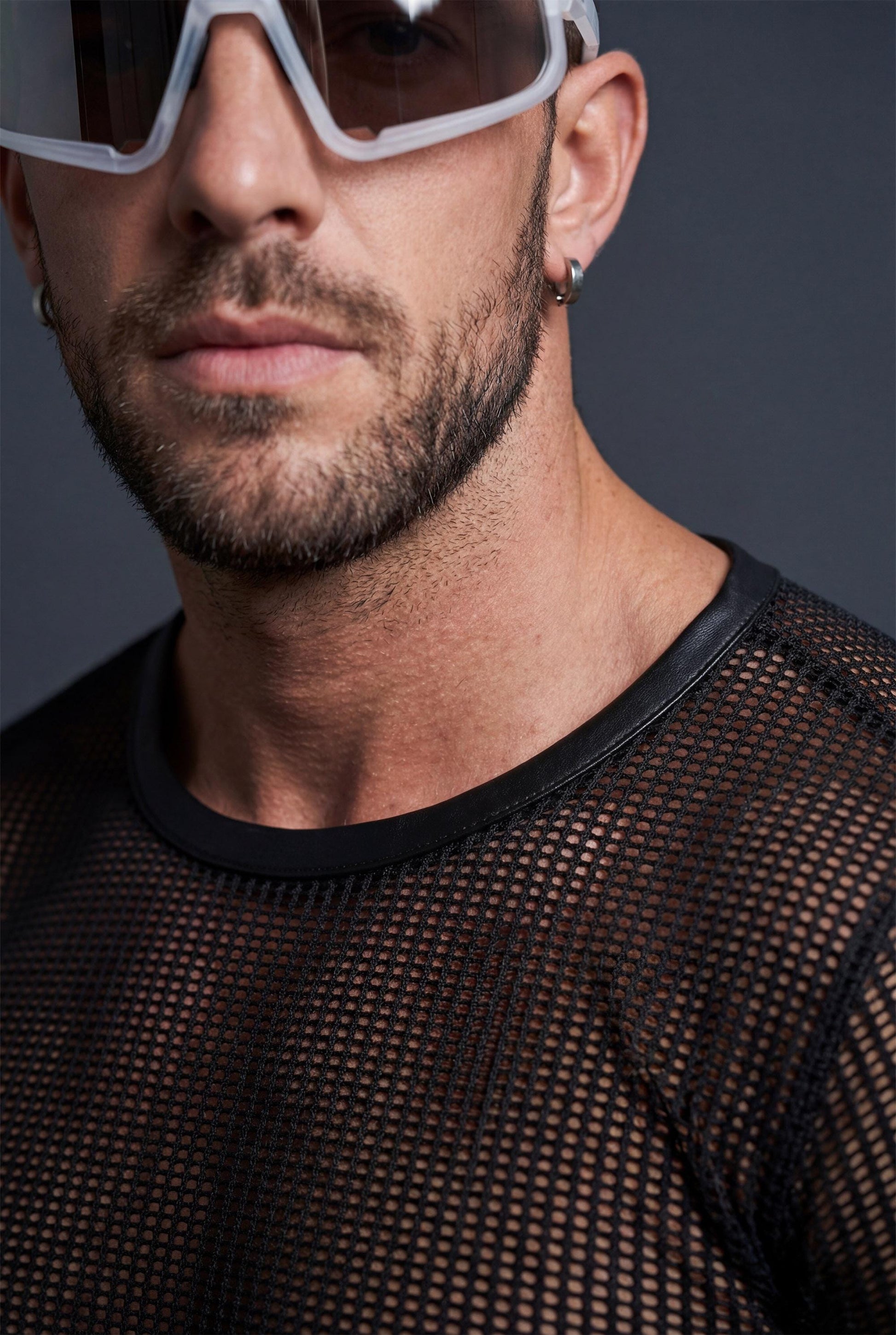 Close-up detail of breathable mesh fabric texture in black for lightweight rave crop top men