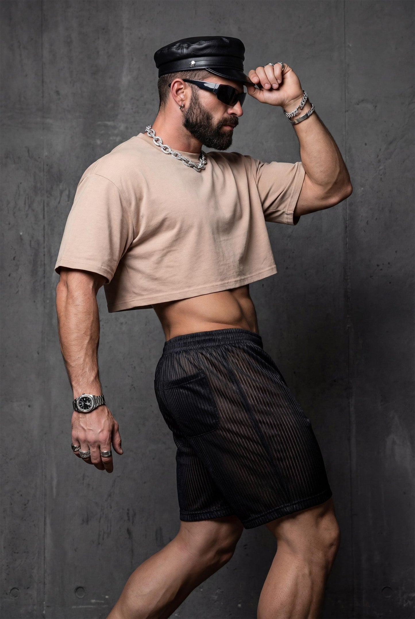 Size chart for black semi-transparent mesh shorts men with metallic pinstripe showing one size fits S-L. Elastic waistband allows flexibility. Unisex design for comfortable transparent rave wear, gay festival fashion, circuit party outfit, and poolside style. Consult guide for ideal fit with confident bold shimmering aesthetic and self-expression.