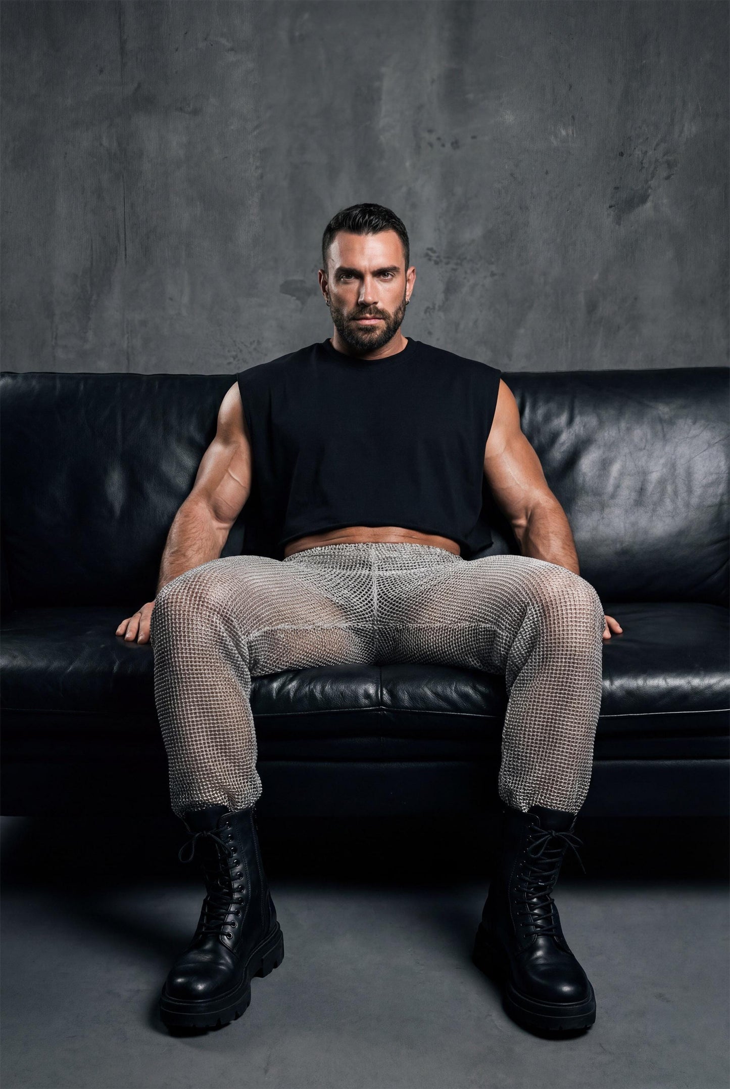 Beige see-through knit mesh jogger pants men with elastic cuffs and drawstring waist, perfect for gay casual wear, rave festival outfit, and relaxed summer style. Breathable open-knit fabric offers ventilation while creating unique textured look. Available in beige and black. Ideal for beach parties, festival lounging, pride events, and casual clubwear. Elastic waistband ensures comfort. Statement piece for men who embrace bold transparent fashion with laid-back confidence and individuality.